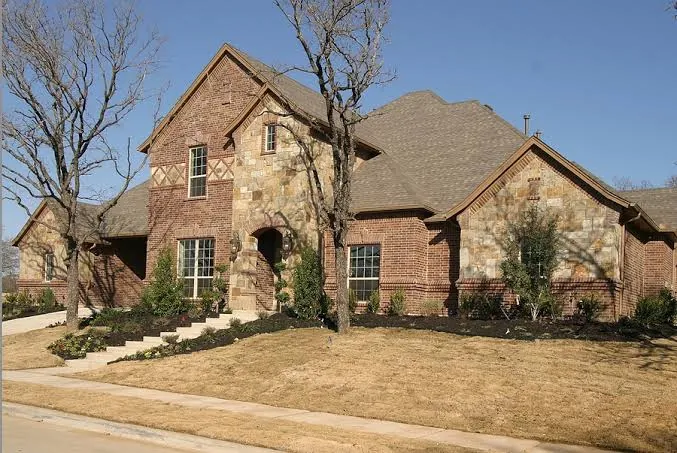 A property with a patchy, worn lawn